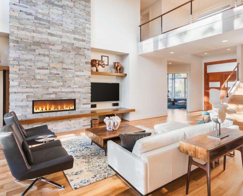 Beautiful living room with hardwood floors and fireplace in new luxury home